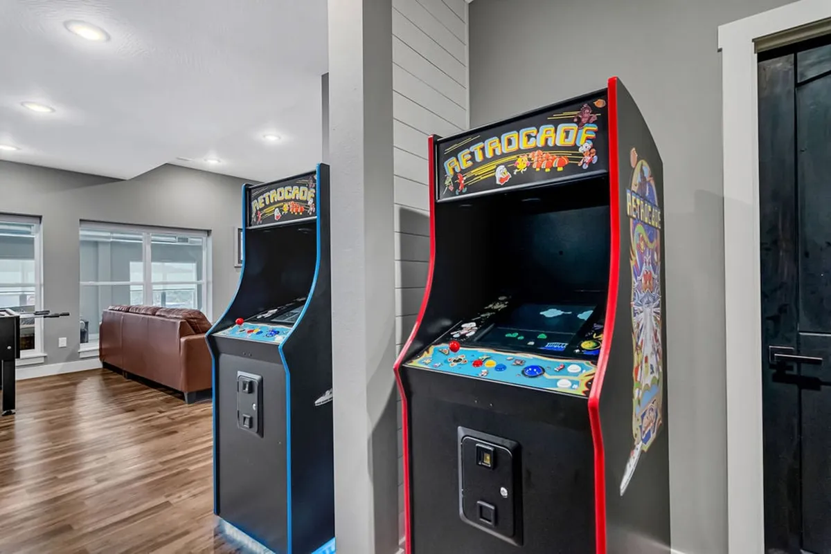 A vibrant, playful game room with modern arcade machines and stylish seating, inviting guests to engage in friendly competition and shared entertainment.